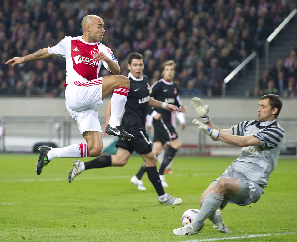 Ajax Amsterdam's Demy de Zeeuw challenges Spartak Moscow's goalkeeper Andriy Dykan during their Europa League soccer match at the Amsterdam Arena